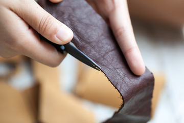 human working on leather