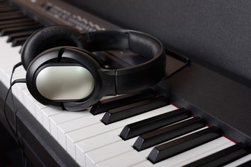 Close-up headphones on piano keyboard