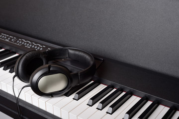 Close-up headphones on piano keyboard