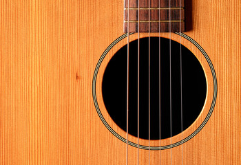 Close-up western guitar on wooden background
