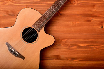 Close-up western guitar on wooden background