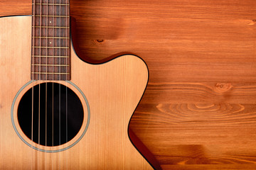 Close-up western guitar on wooden background