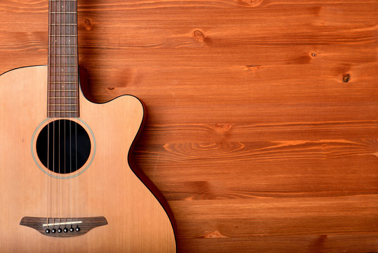 Close-up western guitar on wooden background