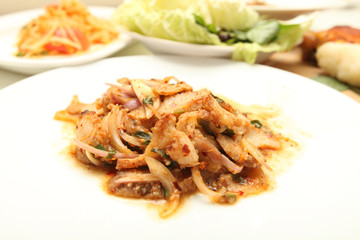 Thai cuisine spicy pork salad , Moo Nam Tok isolated white backg
