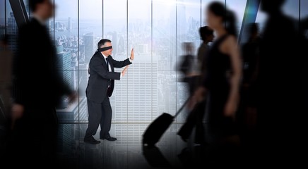 Composite image of mature businessman in a blindfold