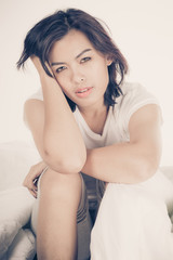 Portrait of a beautiful young woman in bed