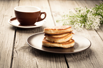 Delicious pancakes with raspberries sauce on the wooden kitchen