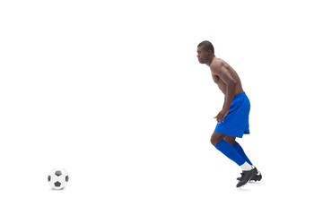Fototapeta na wymiar Shirtless football player moving to the ball
