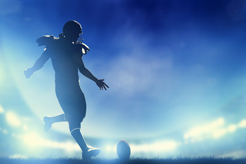 American football player kicking the ball, kickoff - Powered by Adobe