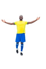 Football player in yellow celebrating a win