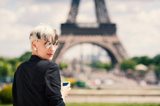 Young woman portrait with mobile phone in Paris, France.