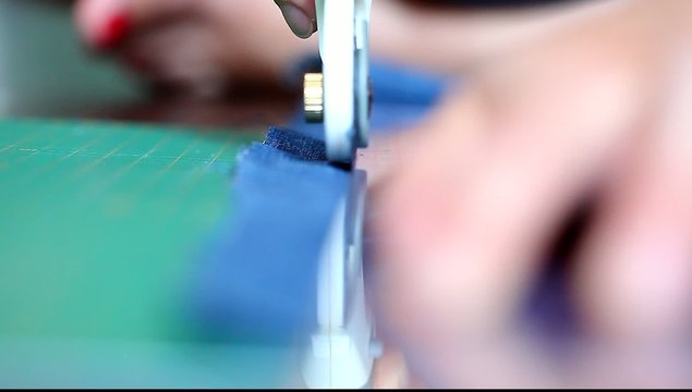 cutting denim rotary knife with a ruler on the mat