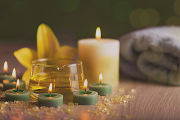 SPA still life with herbal oil  towel over green background