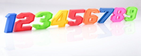 Colorful plastic numbers on a white