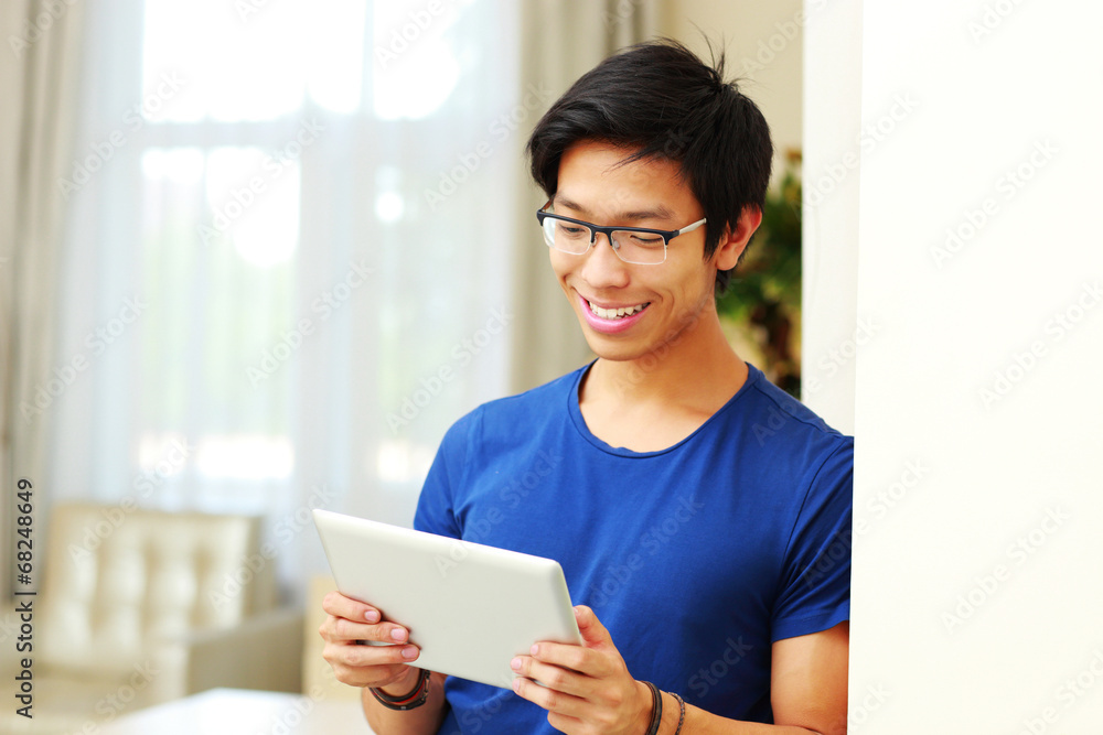 Sticker Happy asian man using tablet computer at home