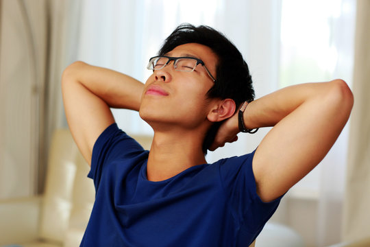 Asian Man Relaxing At Home