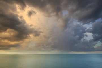 Dramatic tropical rain cloud sky and sea at dusk