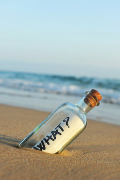 What? bottle with question on the beach