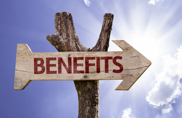 Benefits wooden sign on a beautiful day