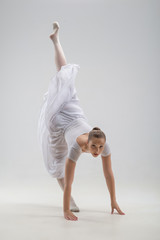 Naklejka premium Young and beautiful ballet dancer posing isolated