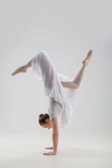 Young and beautiful ballet dancer posing isolated