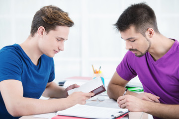 Students taking notes and reading in classroom