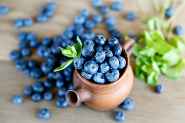 Fresh blueberries in a rustic jug