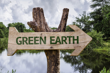 Green Earth wooden sign on a forest background