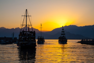 Ship in bay at sunset.