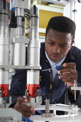 Engineer Working On Machine In Factory