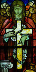 Angel carring the cross of Jesus in stained glass