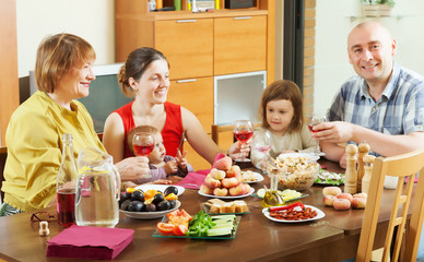 Obraz na płótnie Canvas happy multigeneration family around festive table