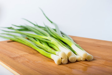 green onion on wooden board