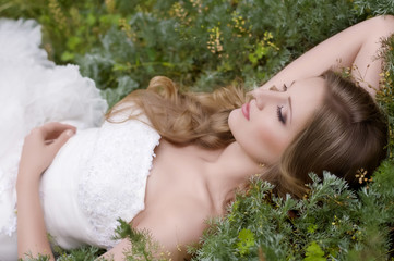 Beautiful bride with stylish make-up in white dress