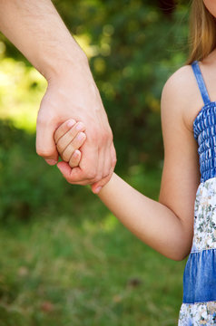 father holding  daughter hand