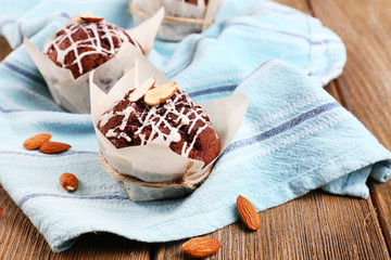 Tasty cupcakes with nuts on table close-up