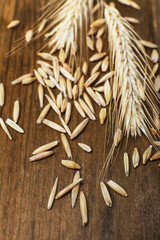 Rye grains and ears on table, close-up