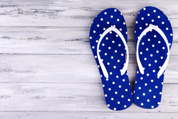 Color flip-flops on wooden background