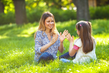 Mother and daughter relaxing in park.