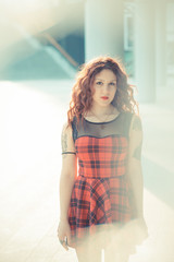 young beautiful hipster woman with red curly hair