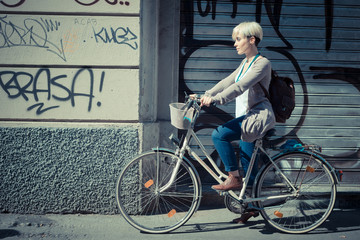 Fototapeta premium beautiful young blonde short hair hipster woman with bike