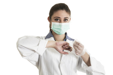 Young female doctor wearing gloves and mask