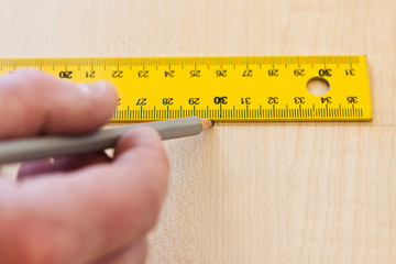 worker draws a line on the board