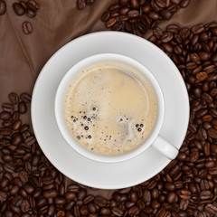 Coffee cup and beans. Selective focus.