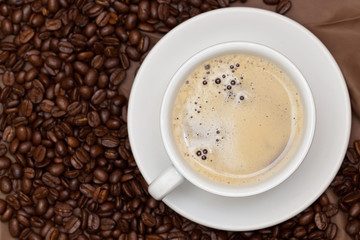 Coffee cup and beans. Selective focus.