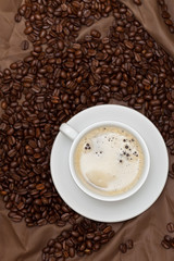 Coffee cup and beans. Selective focus.