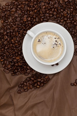 Coffee cup and beans. Selective focus.