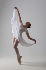 Young and beautiful ballet dancer posing isolated