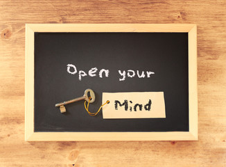 top view of blackboard with the phrase open your mind written on