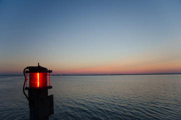 Red lantern by the sea at sunset